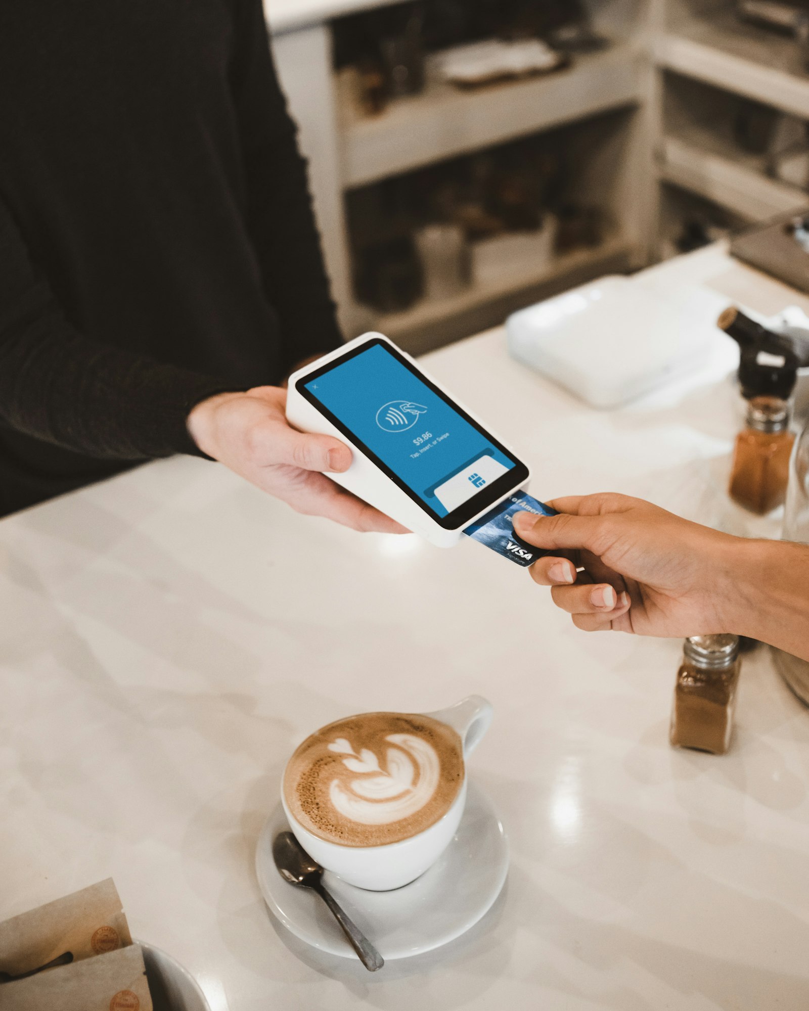 Customer paying by card on a modern payment terminal